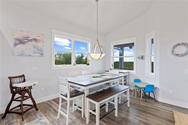 dining area featuring hardwood / wood-style floors and lofted ceiling