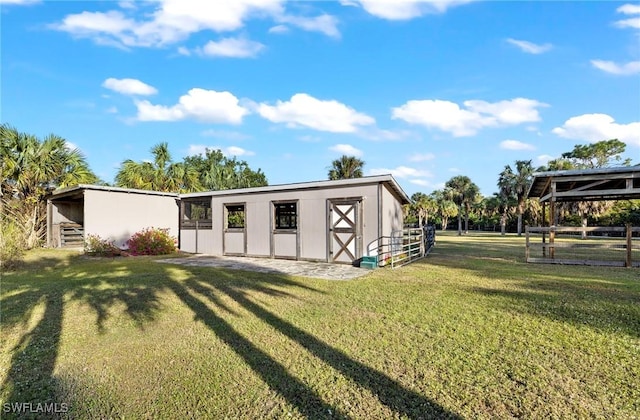 view of outbuilding with a lawn