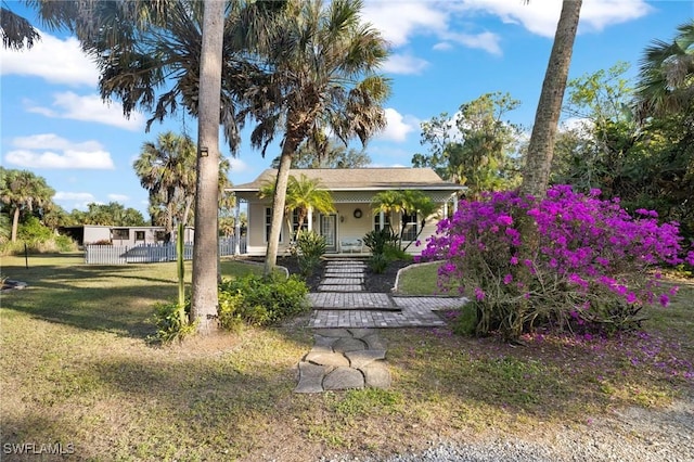 view of front of home featuring covered porch and a front lawn