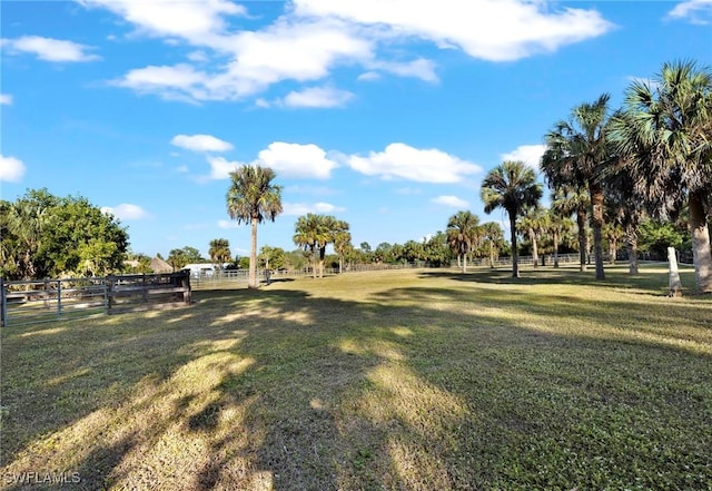 surrounding community with a yard and a rural view