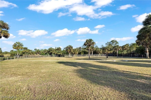 view of property's community featuring a yard and a rural view