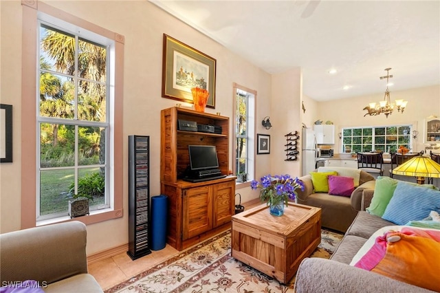 living room featuring light tile patterned flooring and a notable chandelier