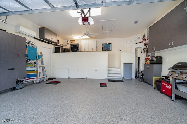 garage featuring a wall unit AC, ceiling fan, and a garage door opener