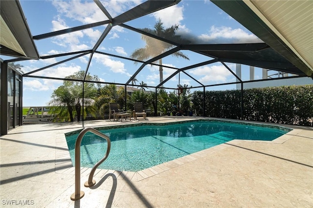 view of swimming pool featuring a patio area and glass enclosure