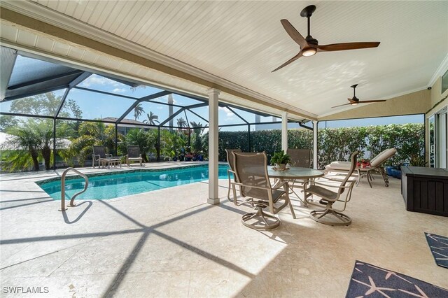 view of pool with glass enclosure, ceiling fan, and a patio area