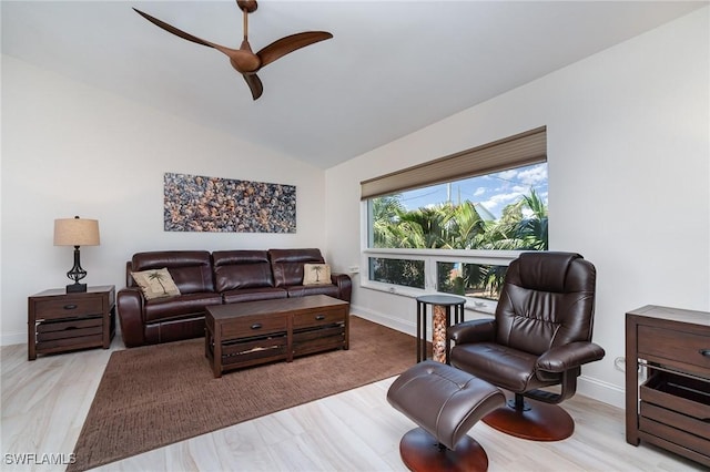 living room featuring ceiling fan, light wood-type flooring, and vaulted ceiling