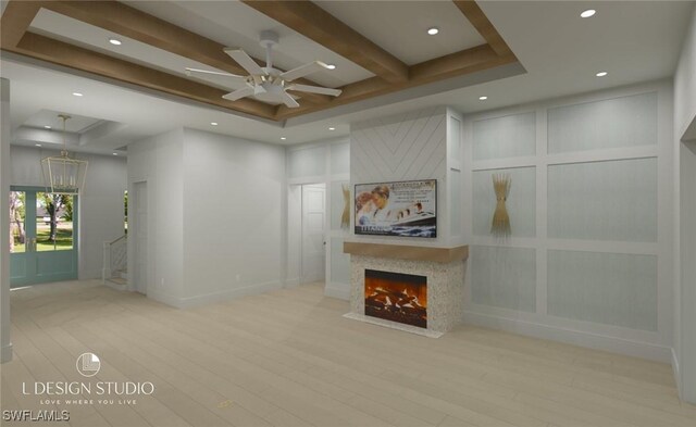 unfurnished living room with ceiling fan, a fireplace, beamed ceiling, and light hardwood / wood-style flooring