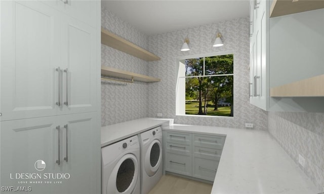 clothes washing area featuring cabinets and independent washer and dryer