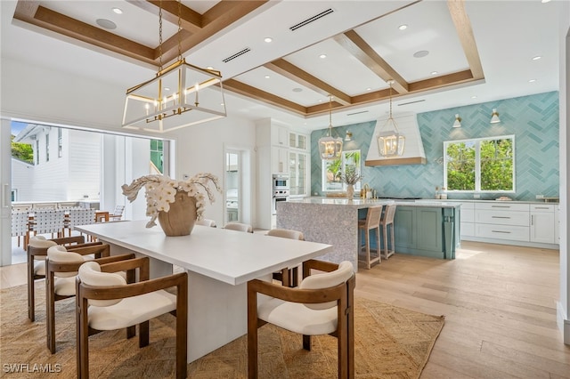 187 10th Ave S, Naples, FL 34102 - dining space featuring light wood finished floors, coffered ceiling, a chandelier, recessed lighting, and beamed ceiling