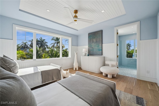 187 10th Ave S, Naples, FL 34102 - bedroom featuring wainscoting, multiple windows, wood finished floors, and a ceiling fan