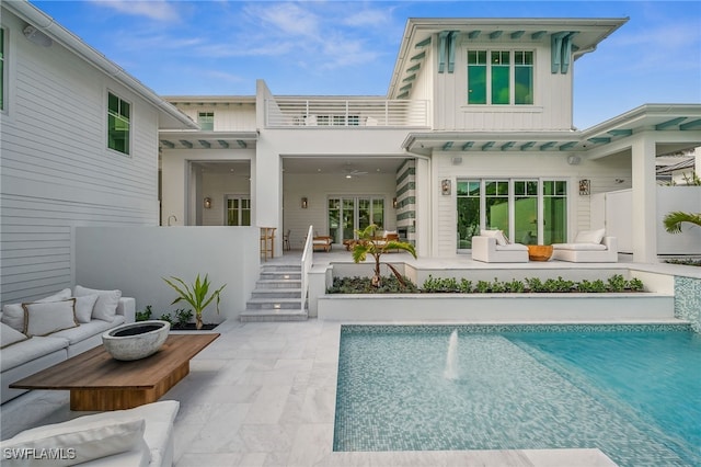 187 10th Ave S, Naples, FL 34102 - rear view of property featuring board and batten siding, a balcony, a patio area, and an outdoor pool