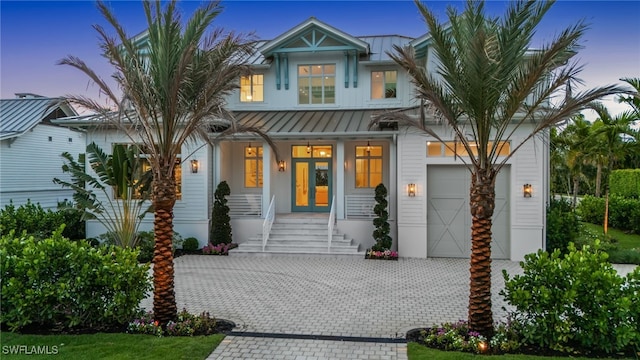187 10th Ave S, Naples, FL 34102 - view of front of property with a standing seam roof, a porch, a garage, decorative driveway, and metal roof
