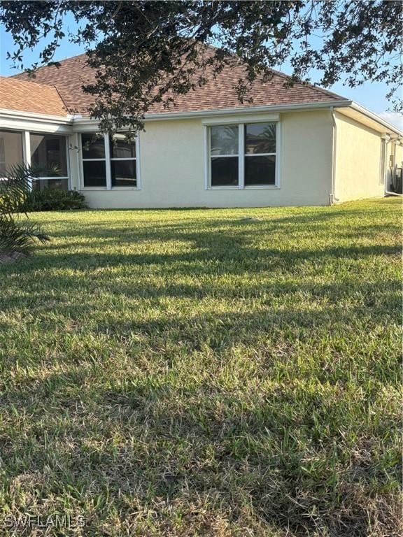 view of side of home featuring a lawn