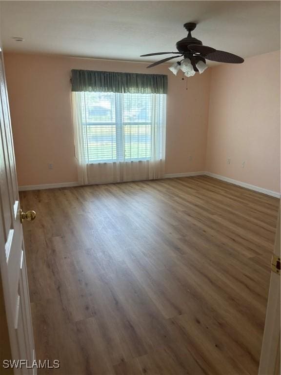 unfurnished room featuring ceiling fan and wood-type flooring