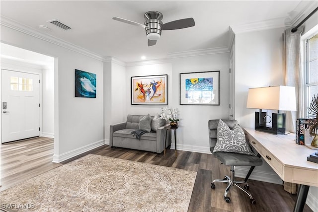 office area featuring visible vents, crown molding, baseboards, and wood finished floors