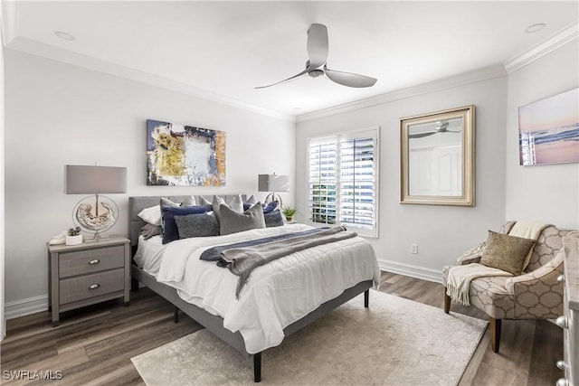 bedroom featuring a ceiling fan, baseboards, crown molding, and wood finished floors