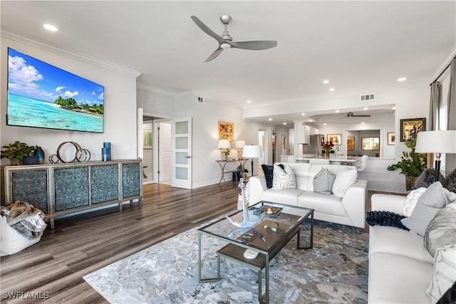 living room with ceiling fan, ornamental molding, wood finished floors, and recessed lighting