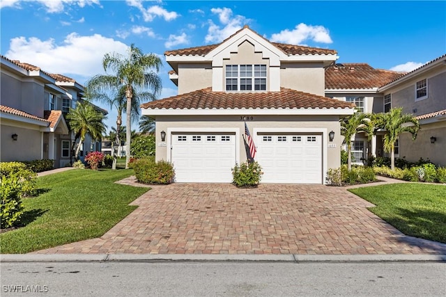 mediterranean / spanish house with a front yard and a garage