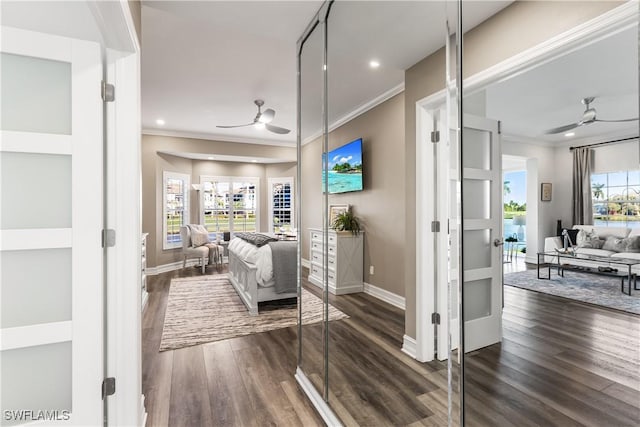 living area with ceiling fan, dark wood finished floors, and crown molding