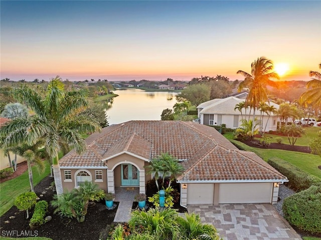 view of front of property with a water view and a garage