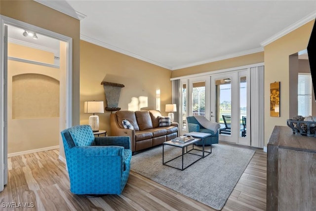 living room with hardwood / wood-style floors, ornamental molding, and french doors