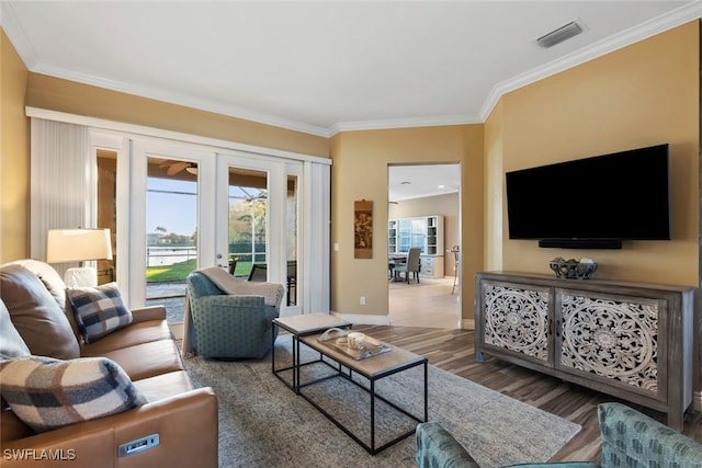 living room featuring crown molding and hardwood / wood-style floors