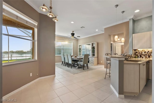 kitchen featuring sink, hanging light fixtures, kitchen peninsula, and ceiling fan