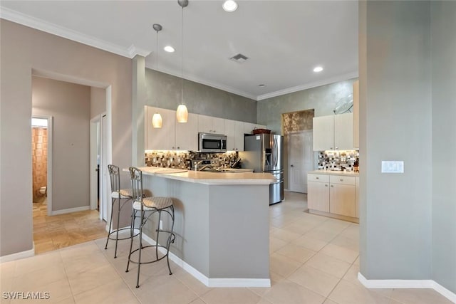 kitchen featuring stainless steel appliances, light tile patterned flooring, a kitchen bar, and kitchen peninsula