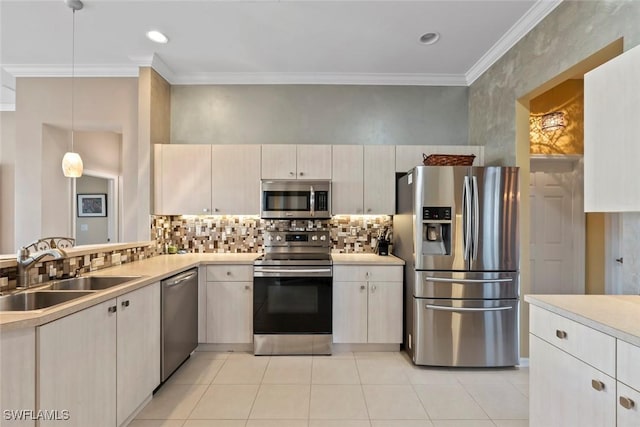 kitchen featuring sink, decorative light fixtures, ornamental molding, stainless steel appliances, and decorative backsplash