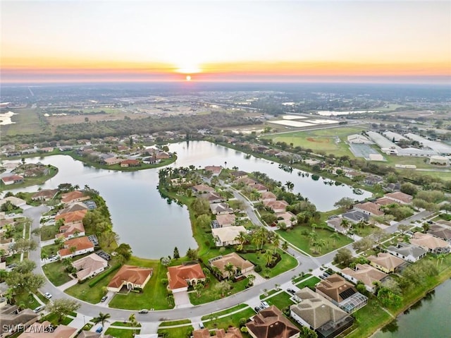 aerial view at dusk with a water view