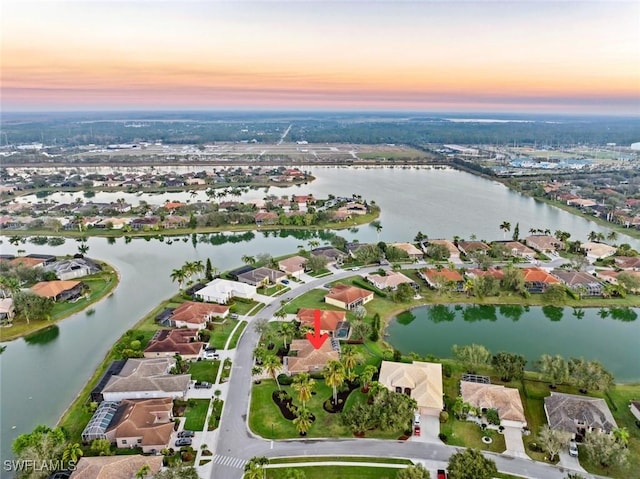 aerial view at dusk with a water view