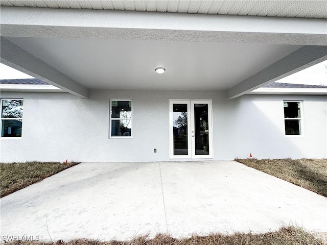 entrance to property with french doors and a patio