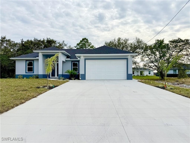 view of front of home with a front yard and a garage