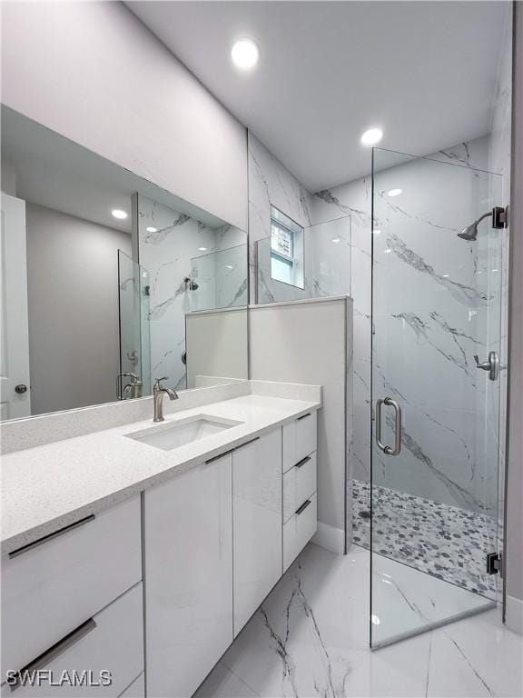 bathroom with a shower with door and vanity