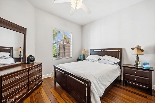 bedroom with dark hardwood / wood-style flooring and ceiling fan