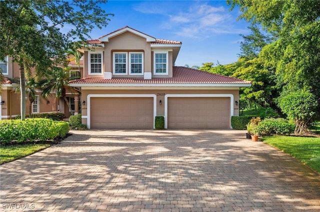 mediterranean / spanish house featuring a garage