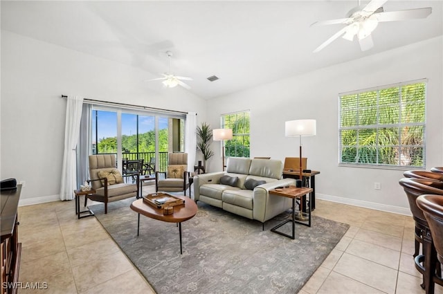 living room featuring baseboards, a ceiling fan, light tile patterned flooring, and lofted ceiling