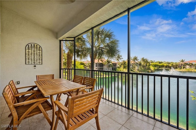 sunroom featuring a water view and vaulted ceiling