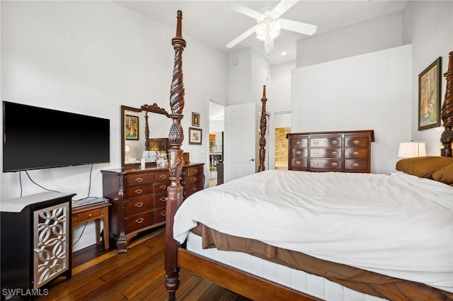 bedroom with a high ceiling, dark hardwood / wood-style flooring, and ceiling fan