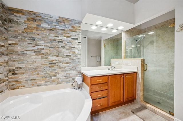 bathroom with tile patterned flooring, a shower stall, a bath, and vanity