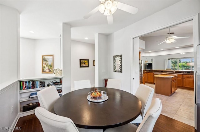 dining room with light hardwood / wood-style floors and ceiling fan