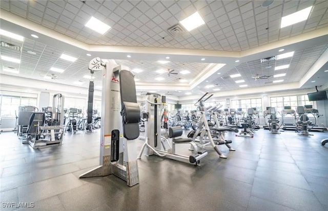 exercise room with plenty of natural light and ceiling fan