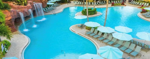 view of swimming pool with pool water feature