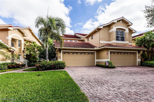 view of front of property with a garage and a front lawn