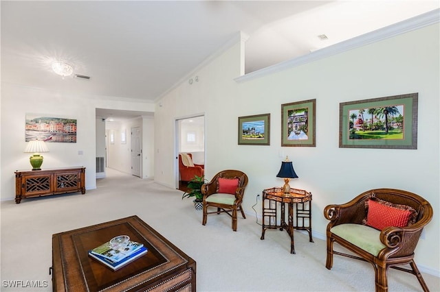 sitting room featuring lofted ceiling, light colored carpet, and ornamental molding