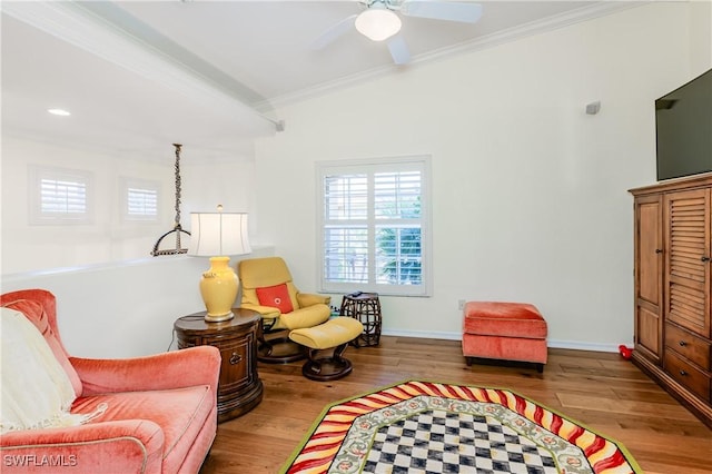 living area featuring ceiling fan, light hardwood / wood-style flooring, and ornamental molding