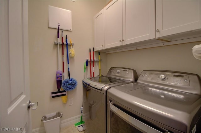 laundry area with cabinets and washing machine and dryer