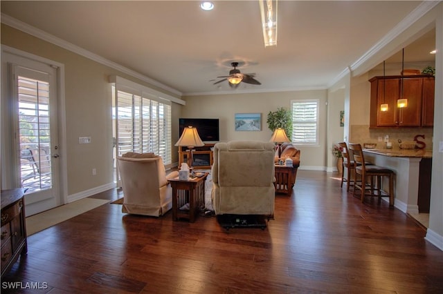 living room featuring dark wood-type flooring, ceiling fan, and ornamental molding