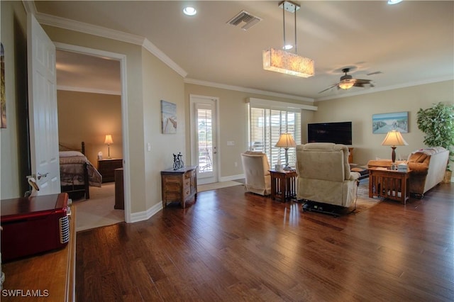 living room with dark hardwood / wood-style floors, ceiling fan, and crown molding