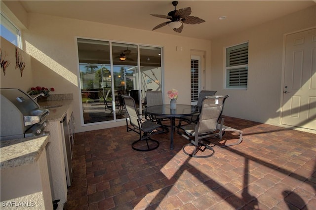 view of patio / terrace with ceiling fan, area for grilling, and grilling area